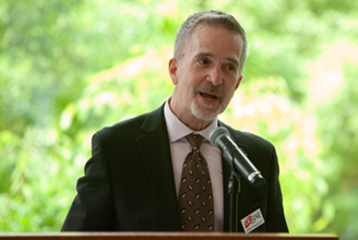 D.C. Bar CEO Bob Spagnoletti speaking into microphone.